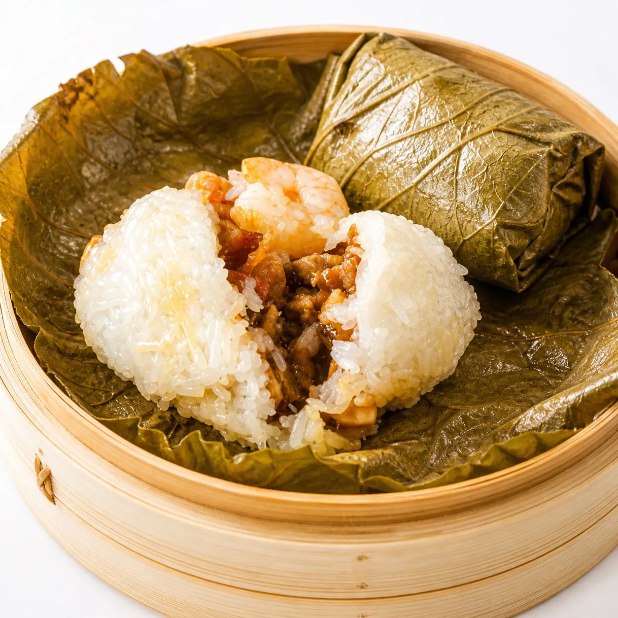 Chicken glutinous rice wrapped in lotus leaf in bamboo steamer