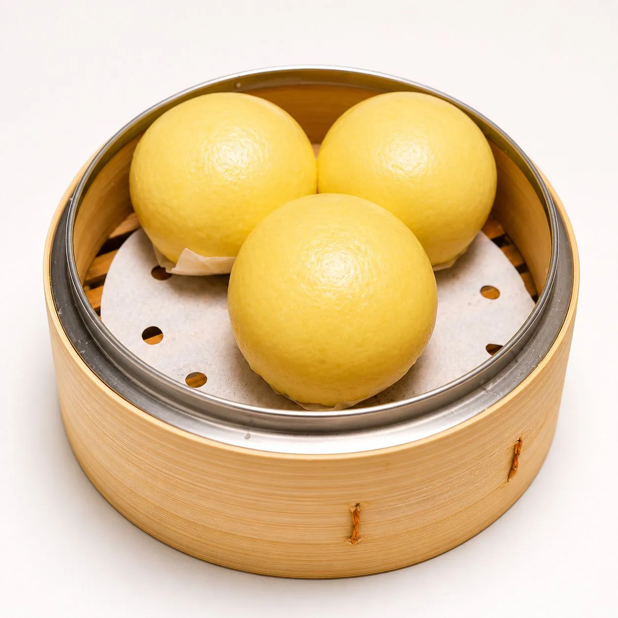 Mini salted egg yolk lava buns in bamboo steamer