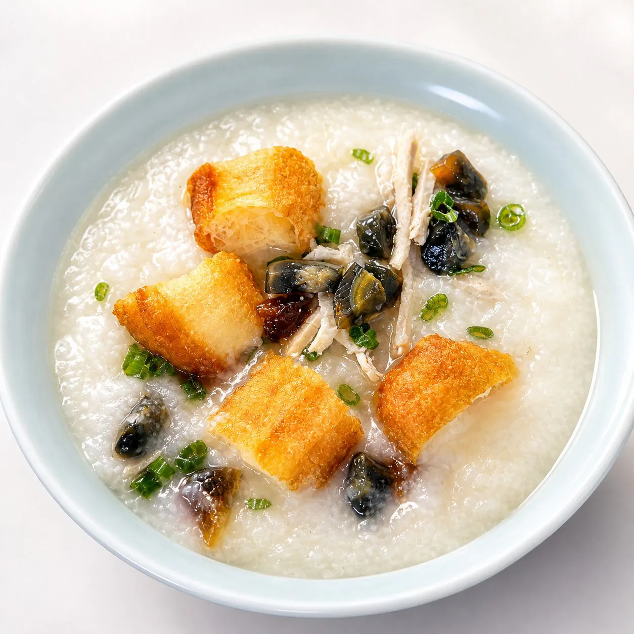 Pork and century egg congee with fried croutons