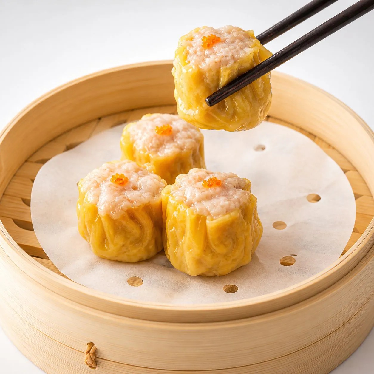 Pork & shrimp dumplings picked by chopsticks in bamboo steamer