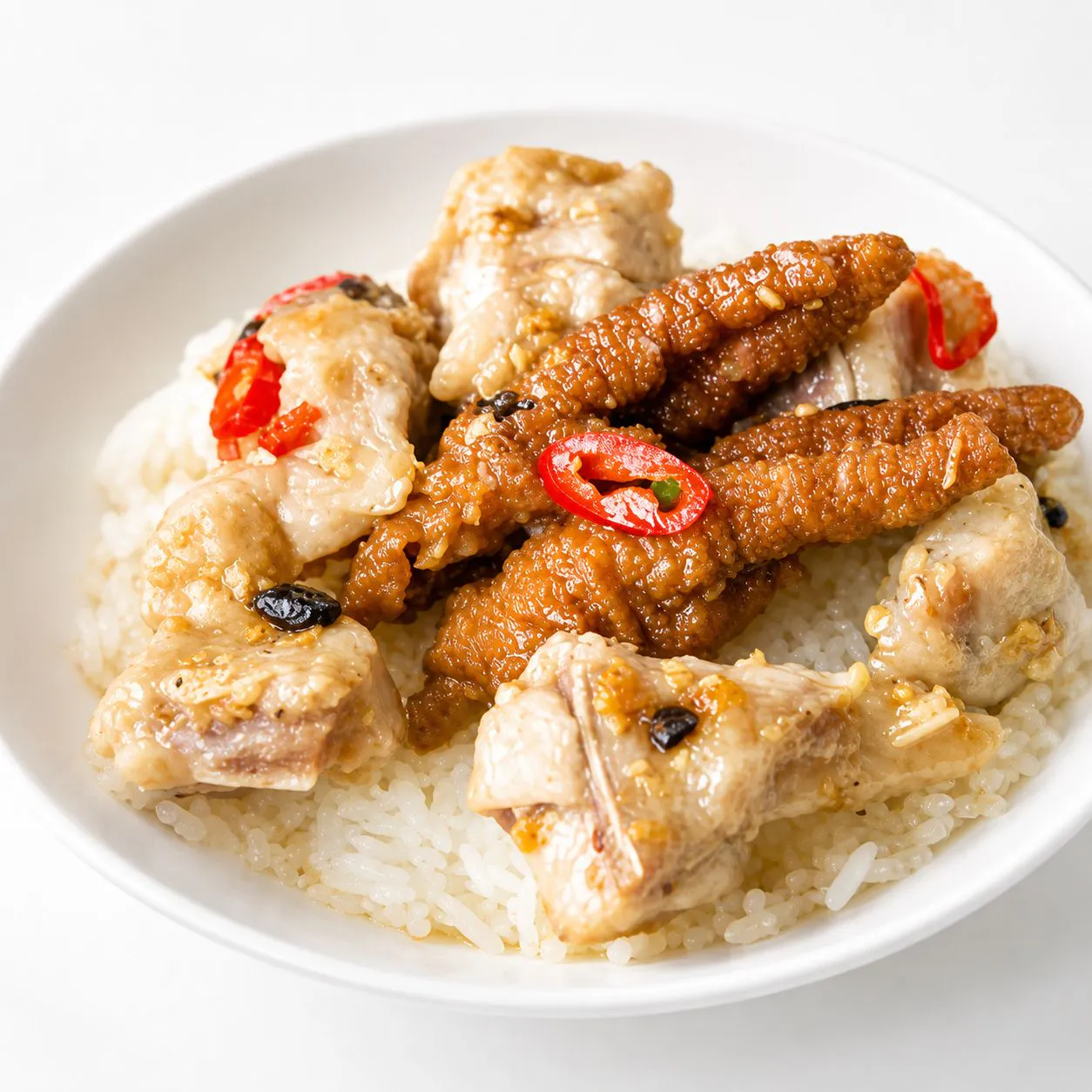Spicy chicken feet and spare ribs over steamed rice