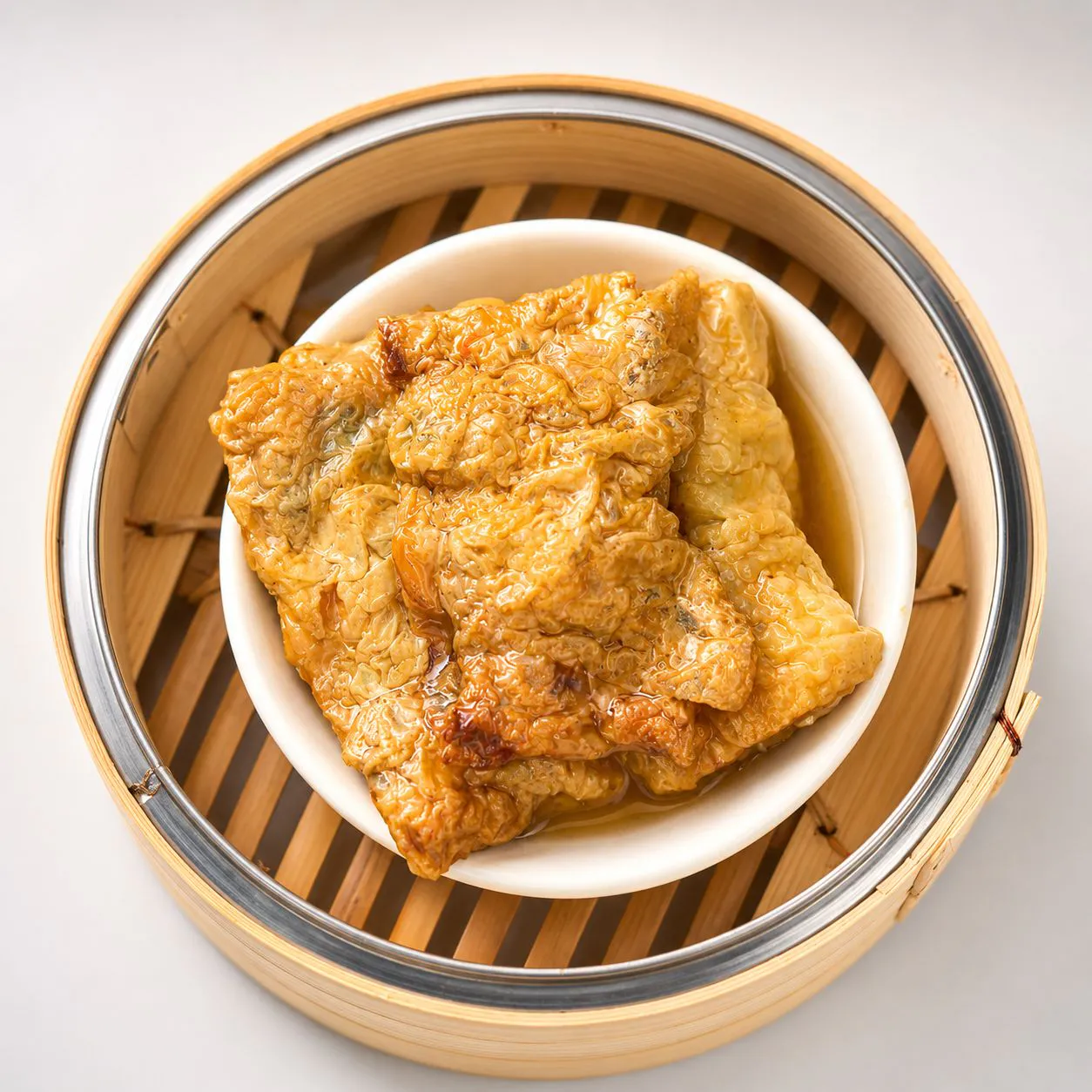 Steamed beancurd roll in bamboo steamer